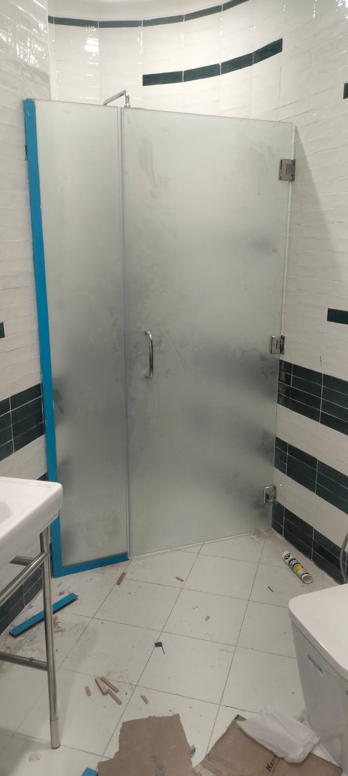 Twin LED bathroom mirrors on mosaic wall